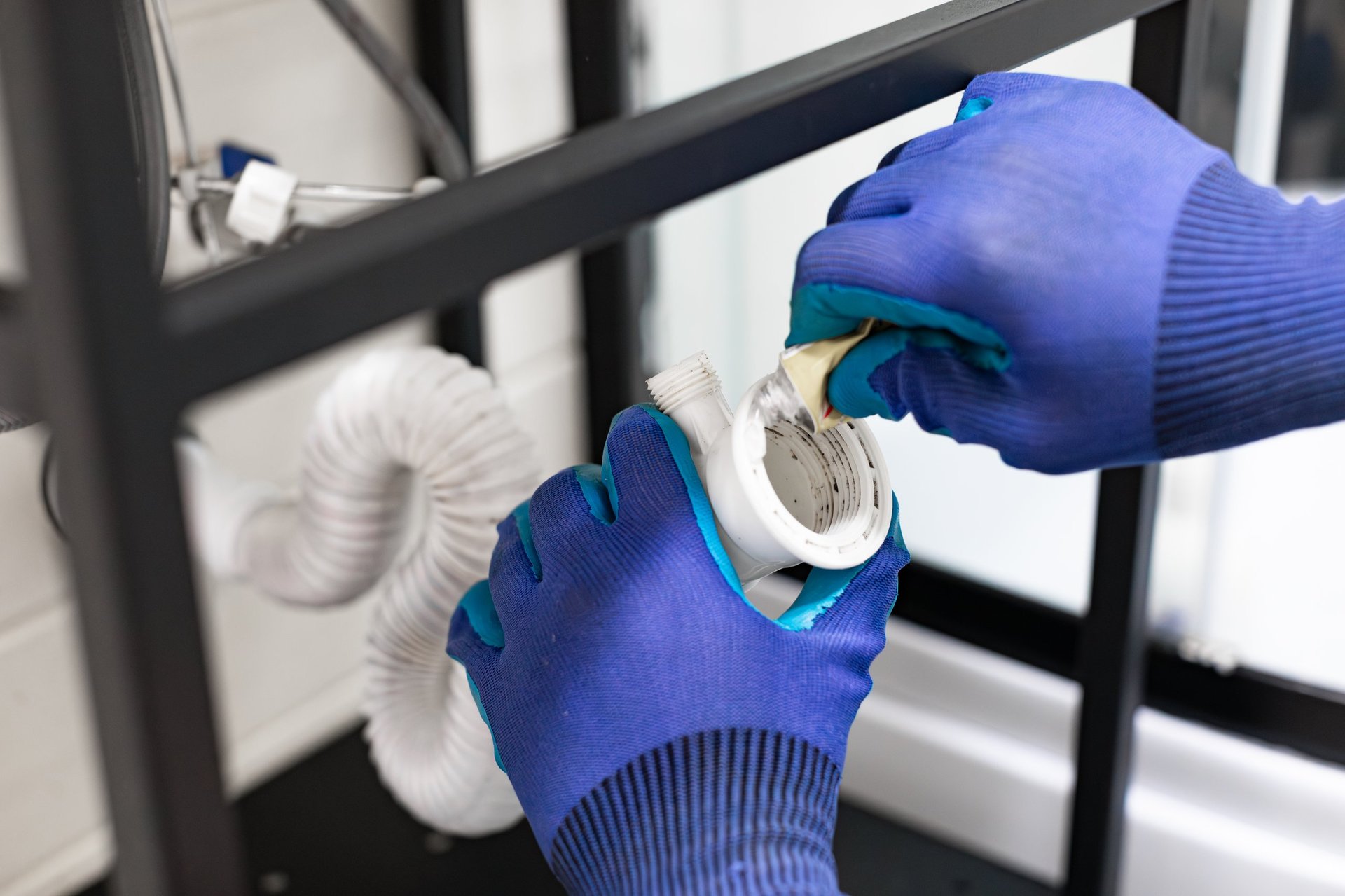 Professional plumber working on sink repair and pipe services