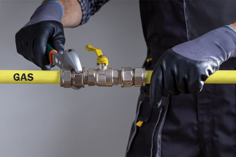 Professional plumber performing gas piping repair